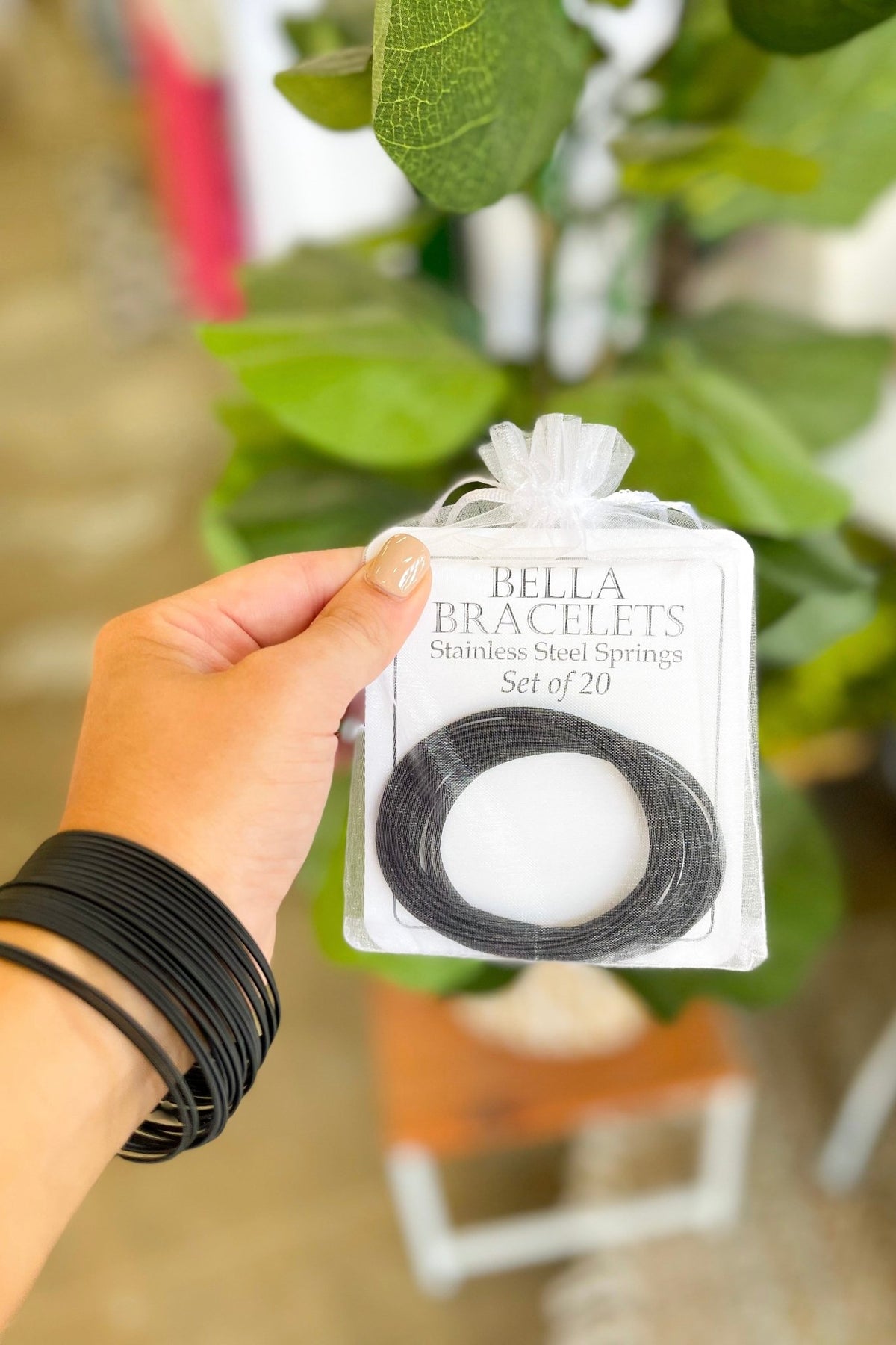 Set of 20 black Bella Bracelets made from stainless steel springs, displayed in a package.